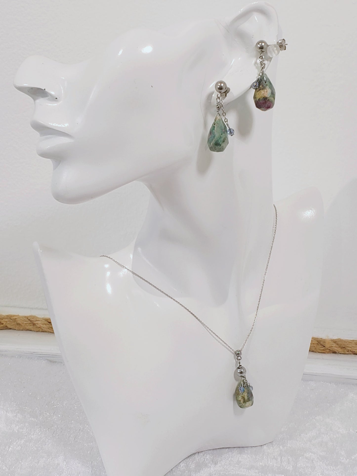 Conjunto de Collar y Aretes de plata 925 presenta una hermosa piedra de Rubí junto con un delicado cristal Swarovski color Azul claro.