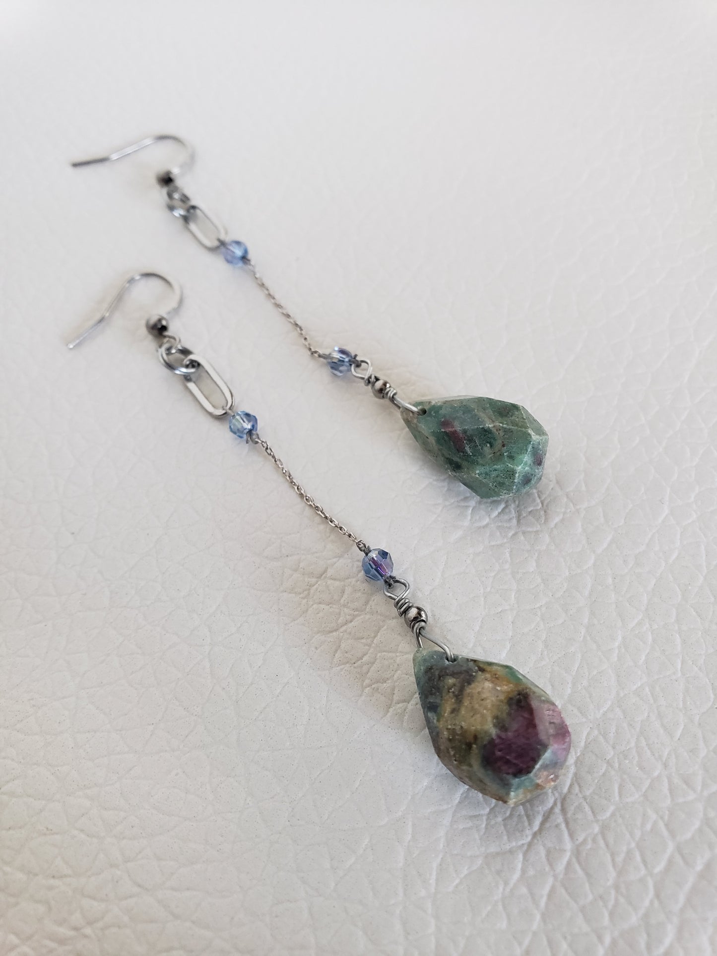 Conjunto de Collar y Aretes de plata 925 presenta una hermosa piedra de Rubí junto con un delicado cristal Swarovski color Azul claro.