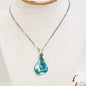 ¡Explora la belleza del mar con este Collar de acero inoxidable y dijes de Lágrimas de Concha - K.Beloved LLC