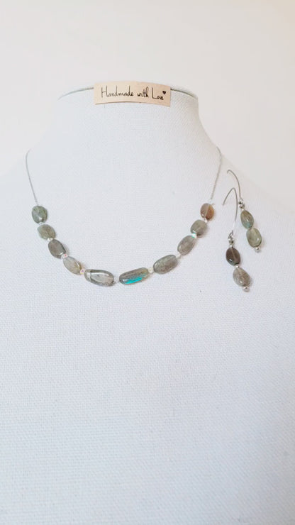 Este elegante juego de collar y aretes de labradorita está elaborado con cuidado y presenta un brillo único que llamará la atención sobre cualquier atuendo.